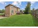 Large grassy backyard with a deck area and an attached three-car garage at 1850 Thomas Ne Dr, Marietta, GA 30066