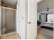 Bathroom with tiled glass enclosed shower, and doorway to bedroom with ceiling fan at 1850 Thomas Ne Dr, Marietta, GA 30066