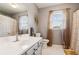 Bathroom with white vanity, toilet, white tile floor, and a shower and tub combination at 1850 Thomas Ne Dr, Marietta, GA 30066