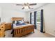 Bedroom features a wooden framed bed and matching dressers under a ceiling fan at 1850 Thomas Ne Dr, Marietta, GA 30066