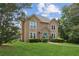 Two story home with a landscaped yard and a bright teal front door sits on a manicured lawn at 1850 Thomas Ne Dr, Marietta, GA 30066