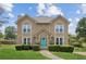 Two story home with a landscaped yard and a bright teal front door on a sunny day at 1850 Thomas Ne Dr, Marietta, GA 30066