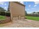 Three car garage is attached to this tan home with a large backyard at 1850 Thomas Ne Dr, Marietta, GA 30066