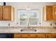 Close-up of the kitchen sink area showcasing granite countertops and a bright window view at 1850 Thomas Ne Dr, Marietta, GA 30066