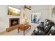 Cozy living room featuring a brick fireplace and view into an adjacent dining area at 1850 Thomas Ne Dr, Marietta, GA 30066