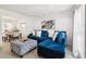 Bright living room with blue sofa, patterned ottoman and dining area in the background at 1850 Thomas Ne Dr, Marietta, GA 30066