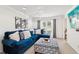 Bright living room with a plush blue sofa, patterned ottoman, and a view of the front yard at 1850 Thomas Ne Dr, Marietta, GA 30066