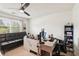 Office with a large window, black leather futon, and built-in shelving unit at 1850 Thomas Ne Dr, Marietta, GA 30066