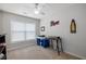 Bright bedroom with carpet, ceiling fan, a window, and a desk setup at 303 Barberry Pl, Canton, GA 30114