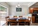 Comfortable dining area with a wooden table, chairs, and a sliding door to the patio and backyard at 303 Barberry Pl, Canton, GA 30114