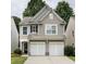 Charming two-story home with a two-car garage, neutral siding and a well-maintained lawn at 303 Barberry Pl, Canton, GA 30114