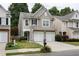 Attractive two-story home featuring neutral siding, a well-kept lawn, and a convenient two-car garage at 303 Barberry Pl, Canton, GA 30114