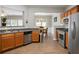 Well-lit kitchen featuring stainless steel appliances, wood cabinets, and an open view to the dining area at 303 Barberry Pl, Canton, GA 30114