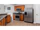 Well-equipped kitchen with stainless steel appliances, wooden cabinets, and modern flooring at 303 Barberry Pl, Canton, GA 30114
