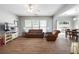 Bright living room with hardwood floors, ample windows, and comfortable seating at 303 Barberry Pl, Canton, GA 30114