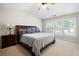 Inviting main bedroom with a large bed, side tables, lamps, and natural light from multiple windows at 303 Barberry Pl, Canton, GA 30114