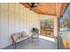 Inviting back porch with tongue and groove ceiling, modern fan, cozy seating, and an outdoor grill area at 3087 Alston Dr, Decatur, GA 30032