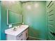 Stylish green bathroom featuring a modern vanity and mirror with white flowers at 3087 Alston Dr, Decatur, GA 30032