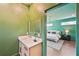 Half-bath connected to bedroom with modern vanity and mirror at 3087 Alston Dr, Decatur, GA 30032