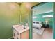 Bathroom vanity with a view to the bedroom with large bed and stylish lighting at 3087 Alston Dr, Decatur, GA 30032