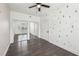 Charming bedroom features wood-look flooring, closet with mirrored doors, and tree-patterned wall at 3087 Alston Dr, Decatur, GA 30032