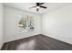 A basic bedroom with a ceiling fan, window and dark wood flooring at 3087 Alston Dr, Decatur, GA 30032