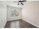 A simple bedroom with dark wood flooring, fan and a window with natural light at 3087 Alston Dr, Decatur, GA 30032