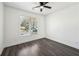Bright bedroom with dark hardwood floors, a ceiling fan, and a large window with blinds at 3087 Alston Dr, Decatur, GA 30032