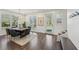 Well-lit dining room with hardwood flooring, a modern chandelier, and views of the outdoors at 3087 Alston Dr, Decatur, GA 30032