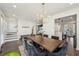 Elegant dining room featuring a large table, modern chandelier, and views into the kitchen at 3087 Alston Dr, Decatur, GA 30032