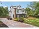 Exterior back of home and lush lawn enclosed with a wooden fence and green trees at 3087 Alston Dr, Decatur, GA 30032