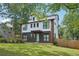 Modern two-story home with gray siding, white trim, black framed windows and a well manicured lawn at 3087 Alston Dr, Decatur, GA 30032