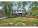 Modern two-story home with gray siding, white trim, black framed windows and a well manicured lawn at 3087 Alston Dr, Decatur, GA 30032