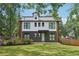 Modern two-story home with gray siding, white trim, black framed windows and a well manicured lawn at 3087 Alston Dr, Decatur, GA 30032