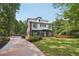 Modern two-story home with gray siding, white trim, black framed windows and a well manicured lawn at 3087 Alston Dr, Decatur, GA 30032