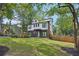 Modern two-story home with gray siding, white trim, black framed windows and a well manicured lawn at 3087 Alston Dr, Decatur, GA 30032
