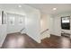 Open hallway with modern staircase, hardwood floors, and natural light flowing from bright windows at 3087 Alston Dr, Decatur, GA 30032