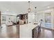 Modern kitchen with island seating and stainless steel appliances that opens up to the living room at 3087 Alston Dr, Decatur, GA 30032