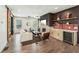Well-lit living room with a fireplace, bar area with wine fridge, and sliding barn door access to another room at 3087 Alston Dr, Decatur, GA 30032
