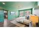 Green main bedroom with modern lighting, barn door to en-suite bath, and plenty of natural light at 3087 Alston Dr, Decatur, GA 30032