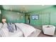 Serene green main bedroom with a seating area, stylish decor, and ample natural light at 3087 Alston Dr, Decatur, GA 30032