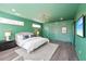 Bright and airy green main bedroom with hardwood floors and stylish modern decor at 3087 Alston Dr, Decatur, GA 30032