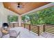 Spacious porch with wood ceiling, fan, grill, seating area and wooden railing overlooking green trees at 3087 Alston Dr, Decatur, GA 30032