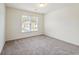 Bedroom with neutral carpet, white walls, a double window, and baseboard trim at 3515 Mcclure Woods Dr, Duluth, GA 30096