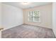 Bright bedroom featuring neutral carpet, white walls, and a double window at 3515 Mcclure Woods Dr, Duluth, GA 30096