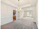 Elegant dining room with decorative molding and chandelier, open to the kitchen at 3515 Mcclure Woods Dr, Duluth, GA 30096