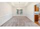 Dining room featuring elegant chandelier, chair railing, and access to kitchen at 3515 Mcclure Woods Dr, Duluth, GA 30096