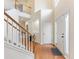 Inviting two-story foyer with hardwood floors, stairs, and a traditional front door at 3515 Mcclure Woods Dr, Duluth, GA 30096