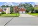 Charming two-story brick home featuring a well-manicured lawn and two-car garage at 3515 Mcclure Woods Dr, Duluth, GA 30096