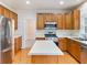 Spacious kitchen with stainless steel appliances, an island and hardwood floors at 3515 Mcclure Woods Dr, Duluth, GA 30096